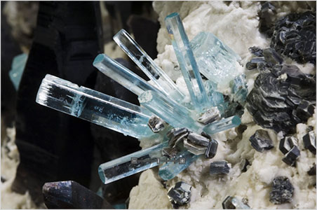 Starburst. Detail of the large aquamarine vug called Diane's Pocket. Discovered in 2004 by prospector Steve Brancato at a claim site near the summit of Mount Antero in the Sawatch Range of central Colorado. The specimen measures 37 inches by 25 inches, and also contains white feldspar, silvery mica, and red garnets, and dozens of black quartz crystals. (Photo: Scott Dressel-Martin, © Denver Museum of Nature and Science)