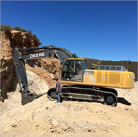 RPL Mining does the heavy lifting at the Mountain Lily Mine. Above, Pala crew member Casey Jones tries to free his toe from the tread of an 80,000-lb. excavator. (We know what's on the iPod in the cab: Carole King .) Photo: Bill Larson)