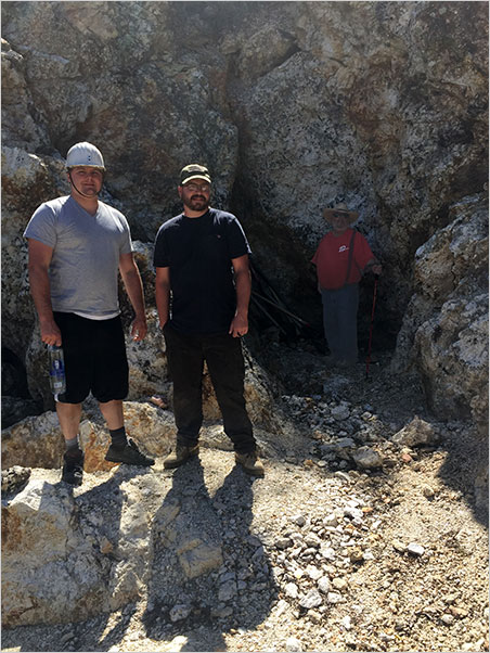 Carl Larson, Kyle Snyder, with David London in back, where he can study the schorl patterns. Note the size of the pegmatite. (Photo: Bill Larson)