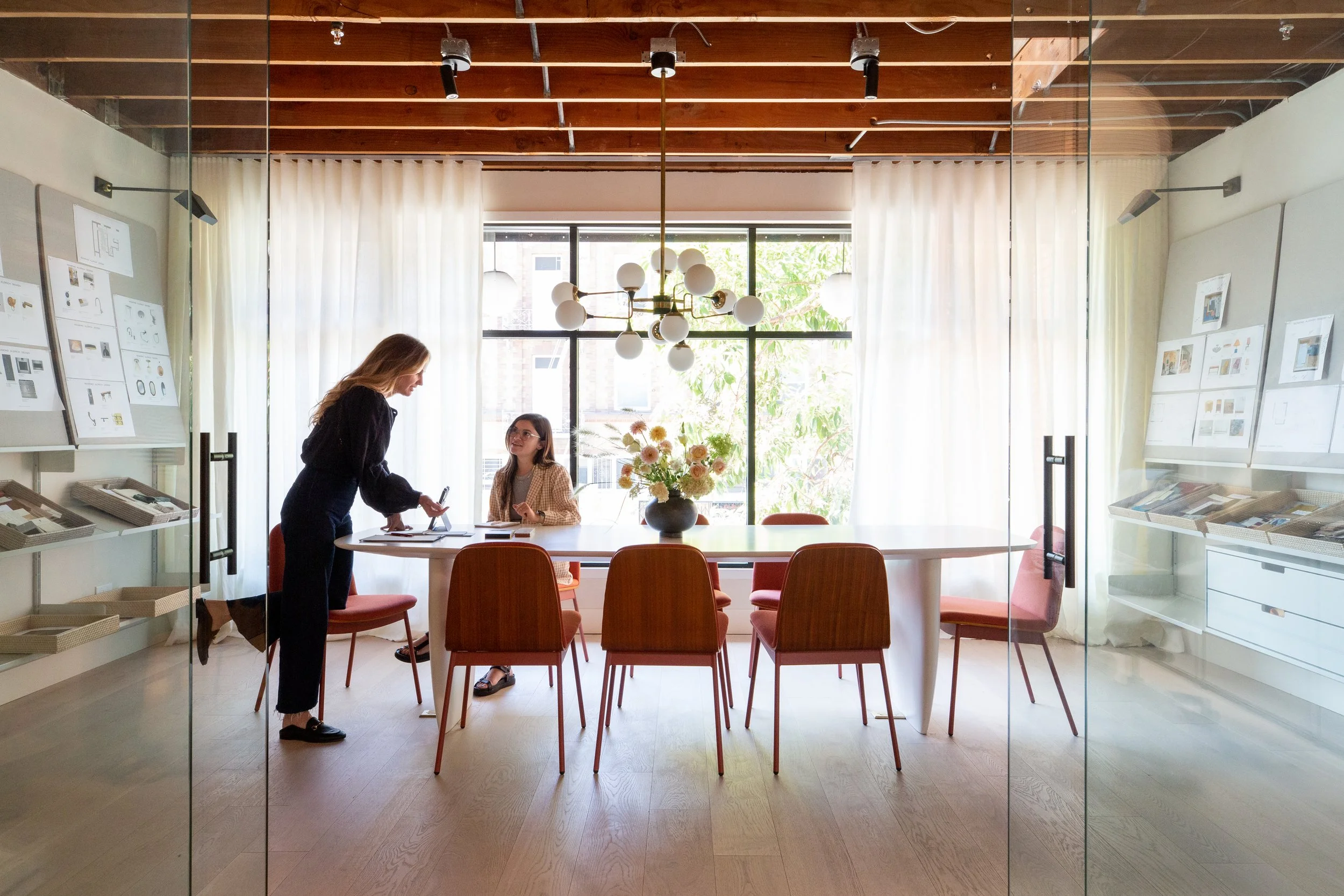 Two women collaborating in a beautiful conference room
