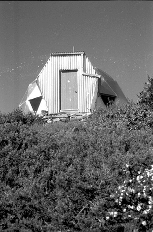  View from in front – roughly from the original proposed location for the toilet. Many weekends were spent drilling, blasting a hole but this was abandoned. The work did provide most of the rocks for the rock wall. 