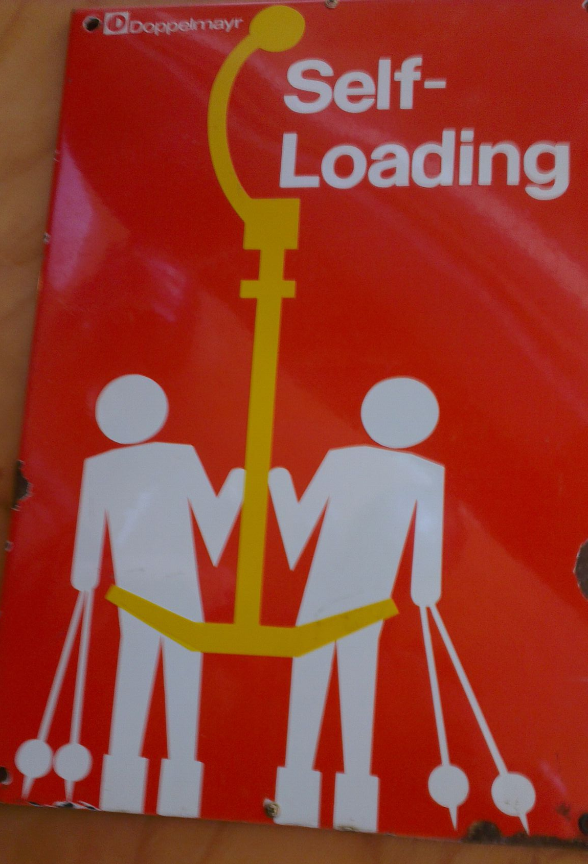 1970's sign preserved at Kellys Cafe, Mt Baw Baw. Self loading T-bars were not a success and today all skiers and boarders using T-bars are assisted by a liftie.