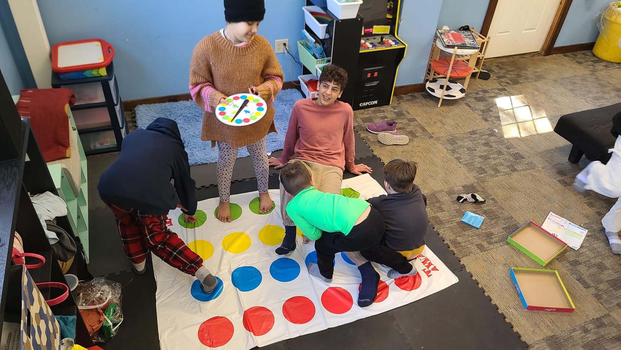 Check out some of our students old and young playing Twister together! We had a parent donate a ton of toys, games, and books all geared towards young children. We set up all of the items in a new &quot;Little Kid Area&quot;. But so far, it seems all