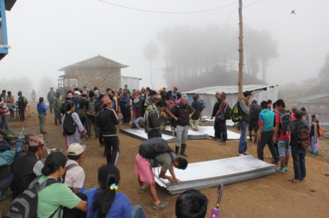 Distribution of corrugated iron for shelter preparation before the monsoon.