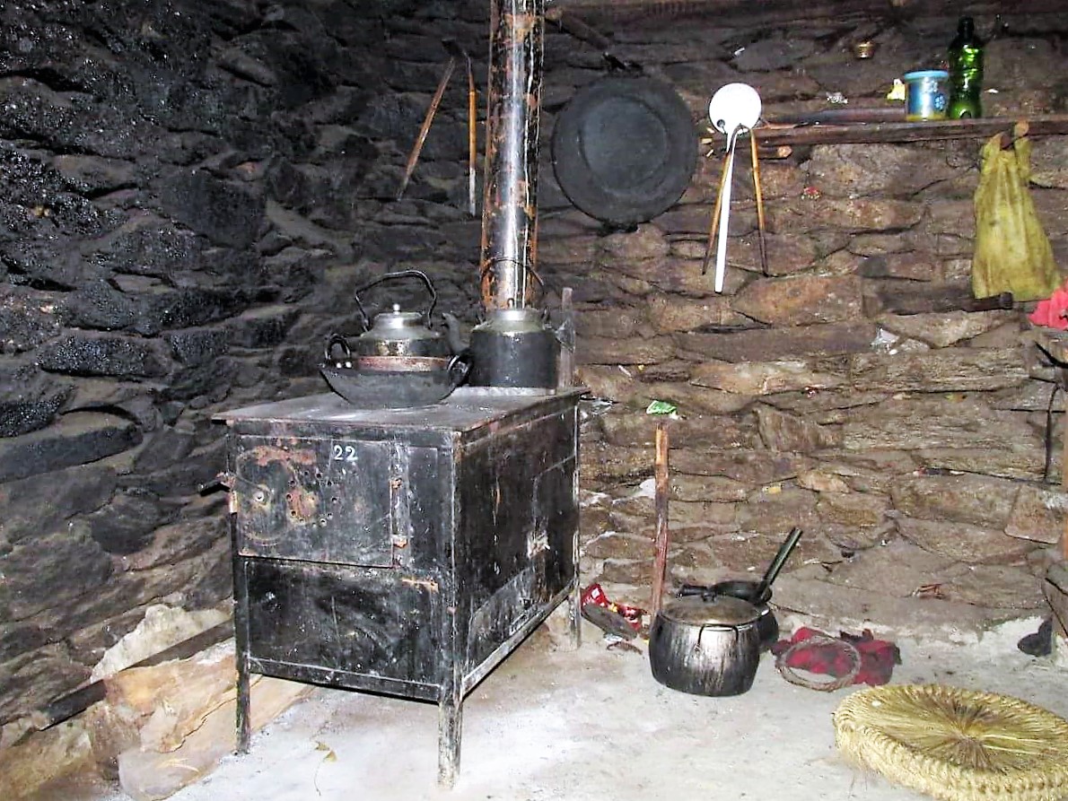 A stove finally installed in a home in Chepuwa. Note the blackened wall behind the stove, this is a result of the soot from the open fire that has burned here for generations before, with the introduction of these stoves, black walls will become a thing of the past. 