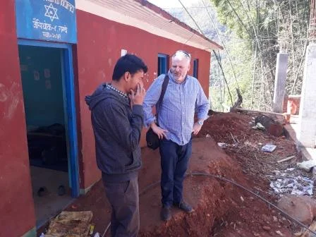 Dr. Craig Hutton and Tribhuvan University student, Amrit in discussion at one of the schools that is being rebuilt. (March 2018)