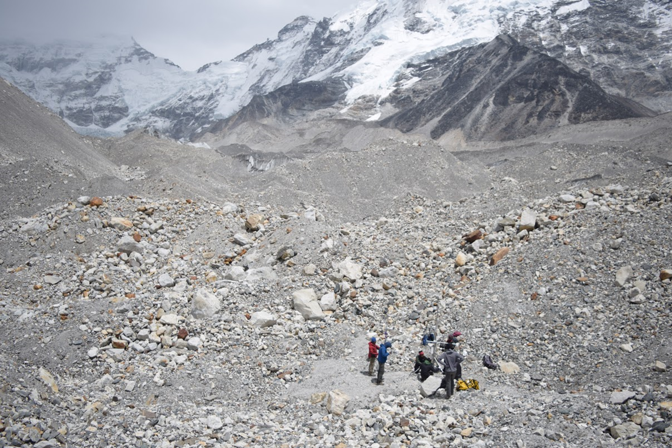 Figure 2 . The debris on this portion of Imja-Lhotse Shar Glacier commonly exceeded one metre. Here, an automatic weather station is being installed during a field expedition in April 2017 to better understand debris-covered glacier melt (credit: Chilton Tippin).