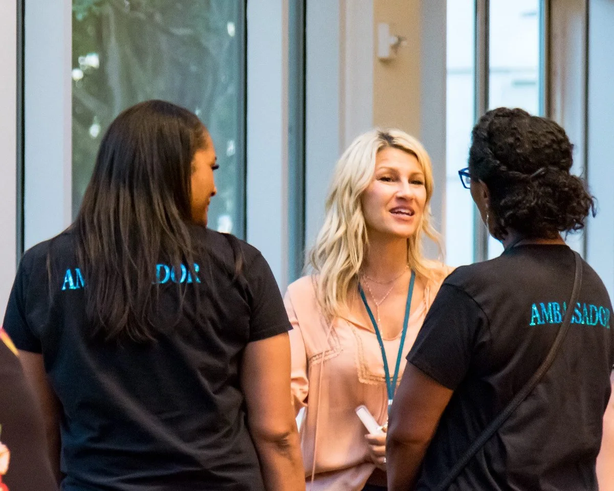 PCOSAA Ambassadors talking with an attendee at PCOS CON 2019