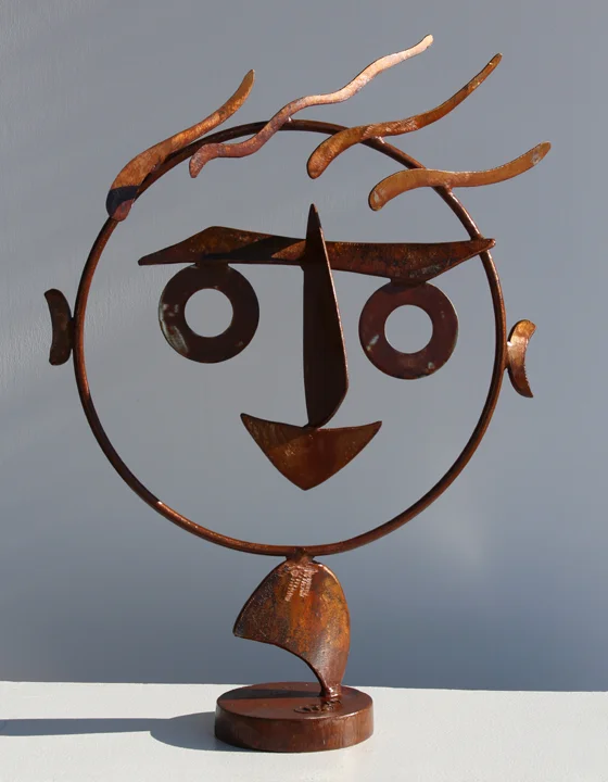Rusted steel figurative sculpture about two feet tall