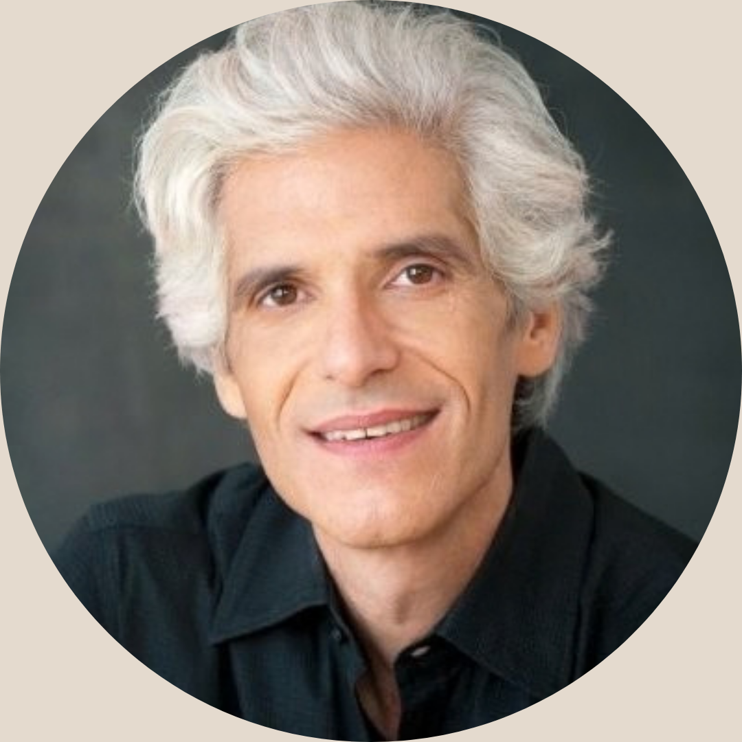 Portrait of a smiling man with gray hair wearing a black shirt