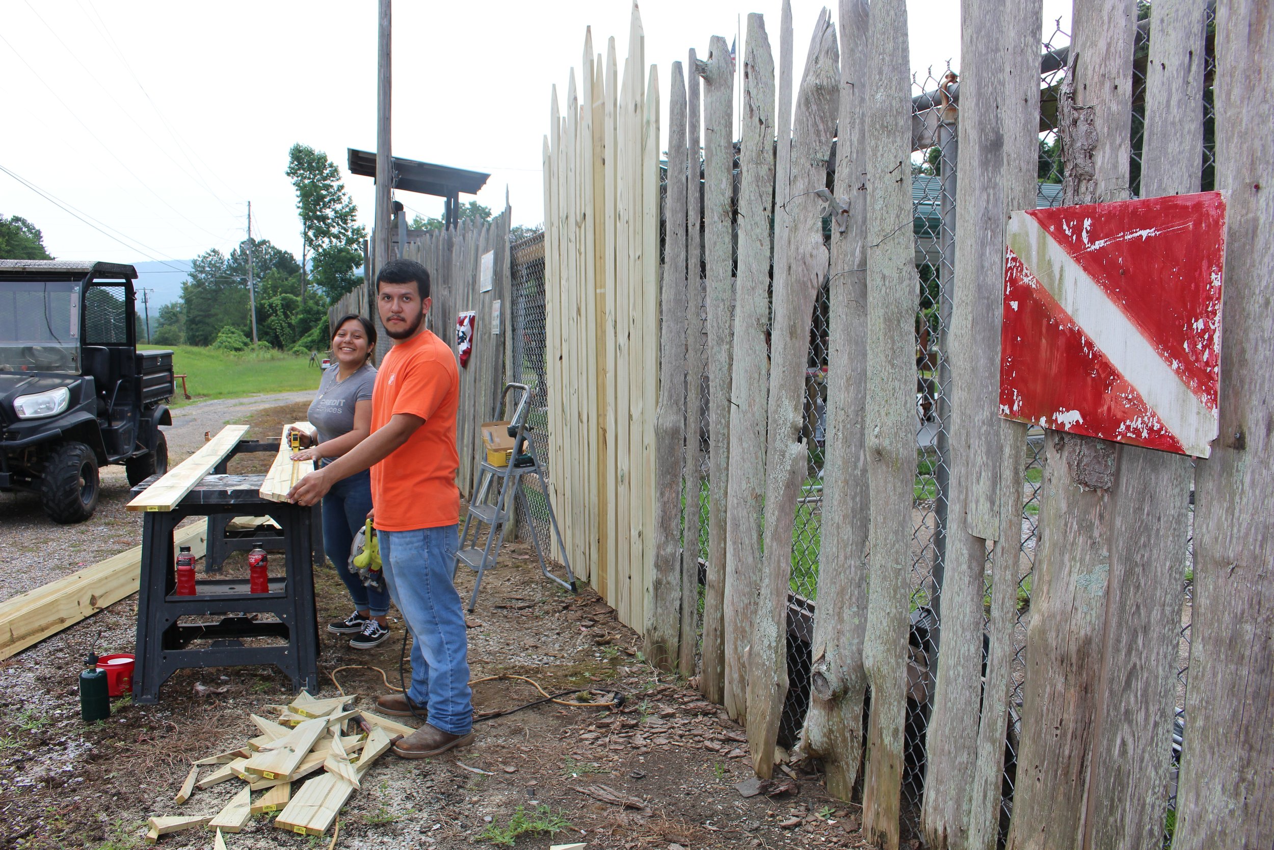 Home Dept of Calhoun team members helping repair our front wood fencing, 2023.JPG