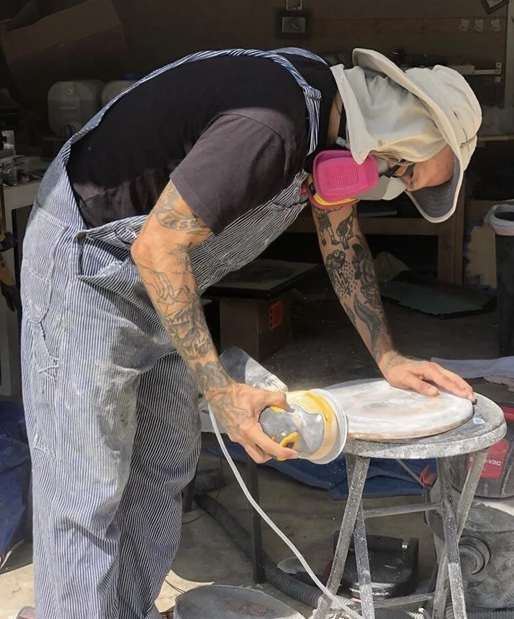 Uncle Jay Riggio sands down one of his Collage works which he glues it to wood, and gives it multiple layers of resin to show drop shadows under his cuts, giving it amazing depth.