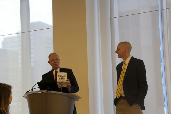 MEF Executive Director Glenn Wilke presented Kevin with a new book titled Wrigley Field: 100 Stories for 100 Years authored by Dan Campana and published by The History Press.