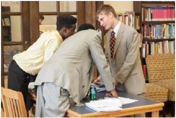 Ben Speckmann Eugene Murawski (right) consults fellow “defense lawyers” Andrew Taylor (left) and Quinton Karamoko during a mock trial Thursday. The event was the culmination of a six-week class sponsored by Winston & Strawn LLP to teach legal basics to 15 students at the Midtown Center.