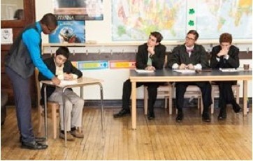 Ben Speckmann (From left to right) Student Patrick Elliott cross-examines classmate Luis Guerrero, playing the role of a fraternity member accused of first-degree murder, as adviser Geoffery Burdell, teacher Zachary Reeder and second assistant Lucas Williams act as judges during a mock trial at the Midtown Center, 1819 N. Wood St., on Thursday. The mock trial resulted from a six-week class sponsored by Winston & Strawn LLP that taught 15 students legal basics and provided a $400 stipend for good behavior.