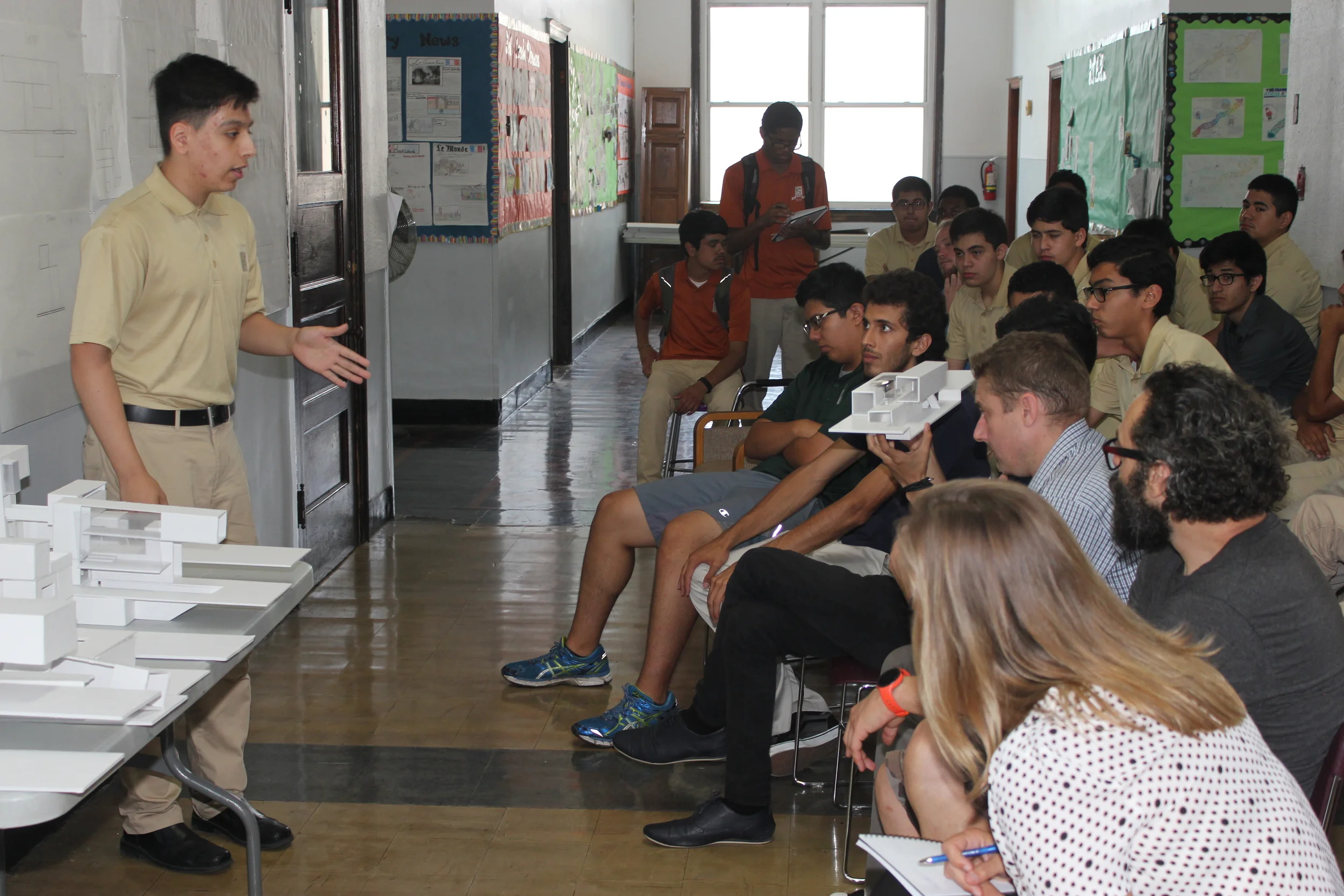 Alejandro, a second-year Architecture apprentice at Midtown, describes his design to the panel of architects.