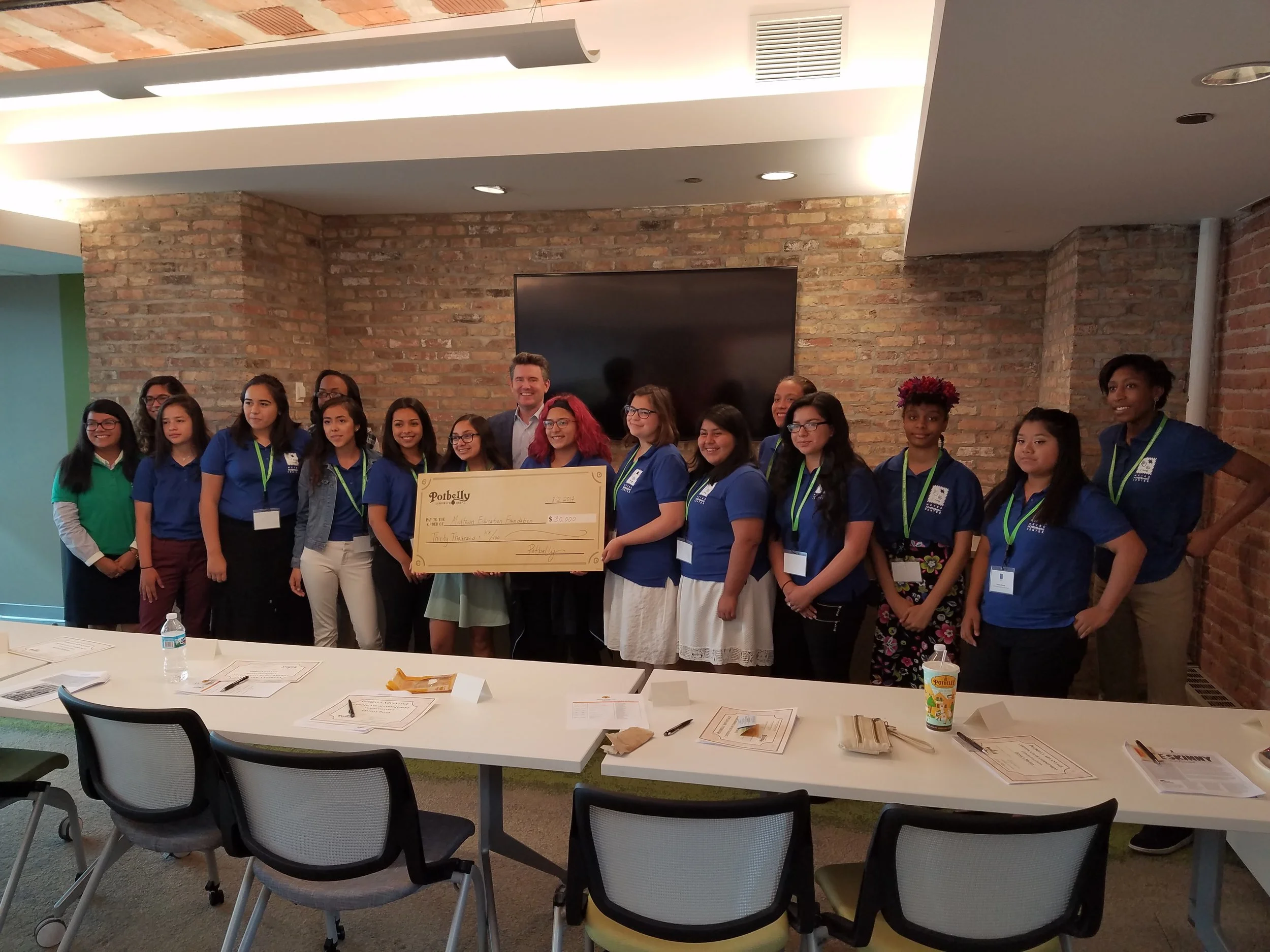 Smiles abound as Mr. Coyne presented the sponsorship check. One of the girls asked him "how to cash it."