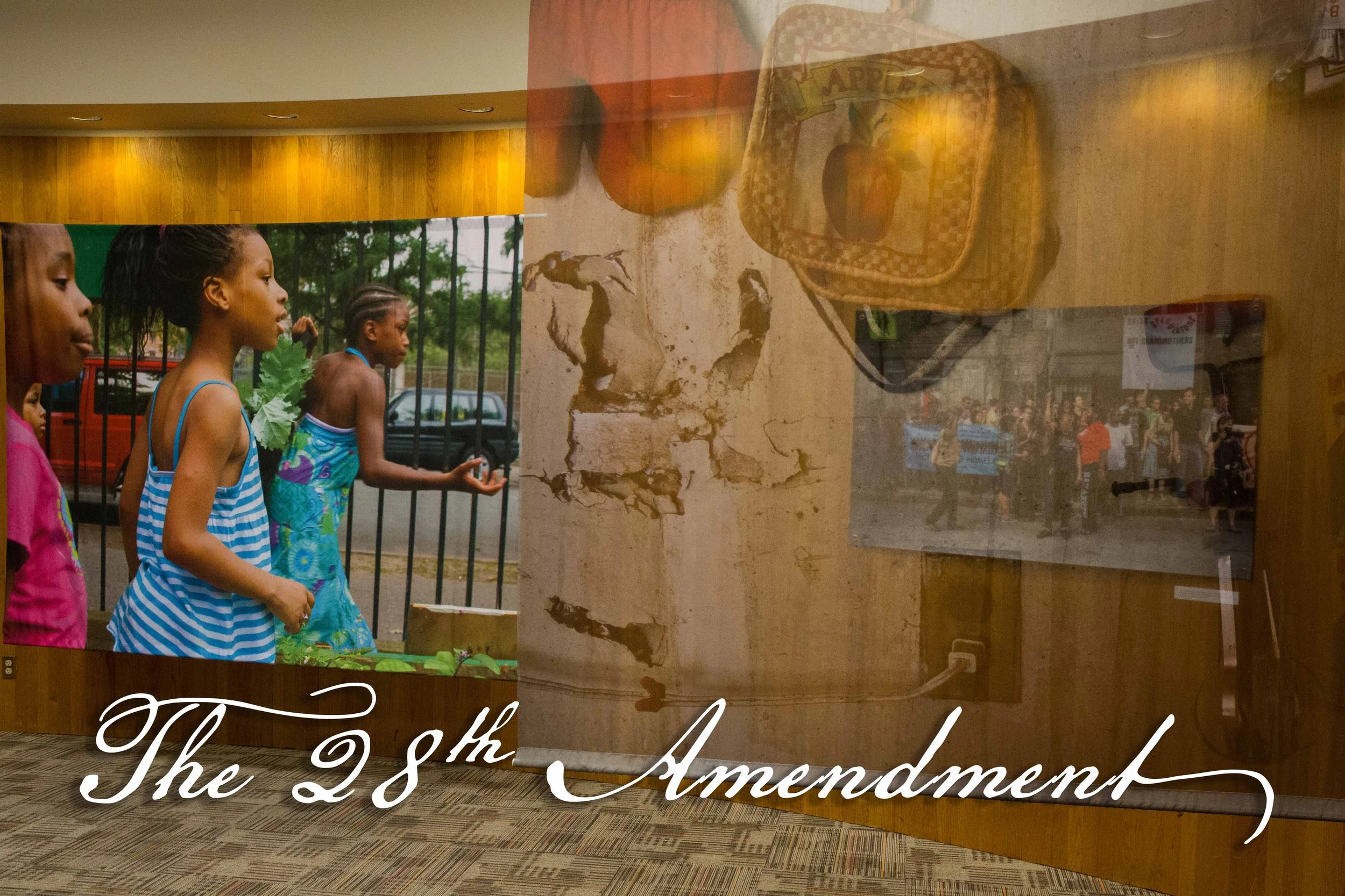Photo of children walking outdoors, wearing colorful summer clothes. Reflection of an interior with a poster about the 28th Amendment on the glass surface.