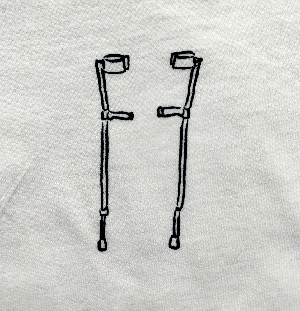 Pictured: Closeup of the two screen printed sticks from the lovebili Sticks Shirt.