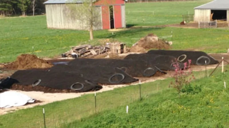 ComposTex Compost Cover covering large compost piles