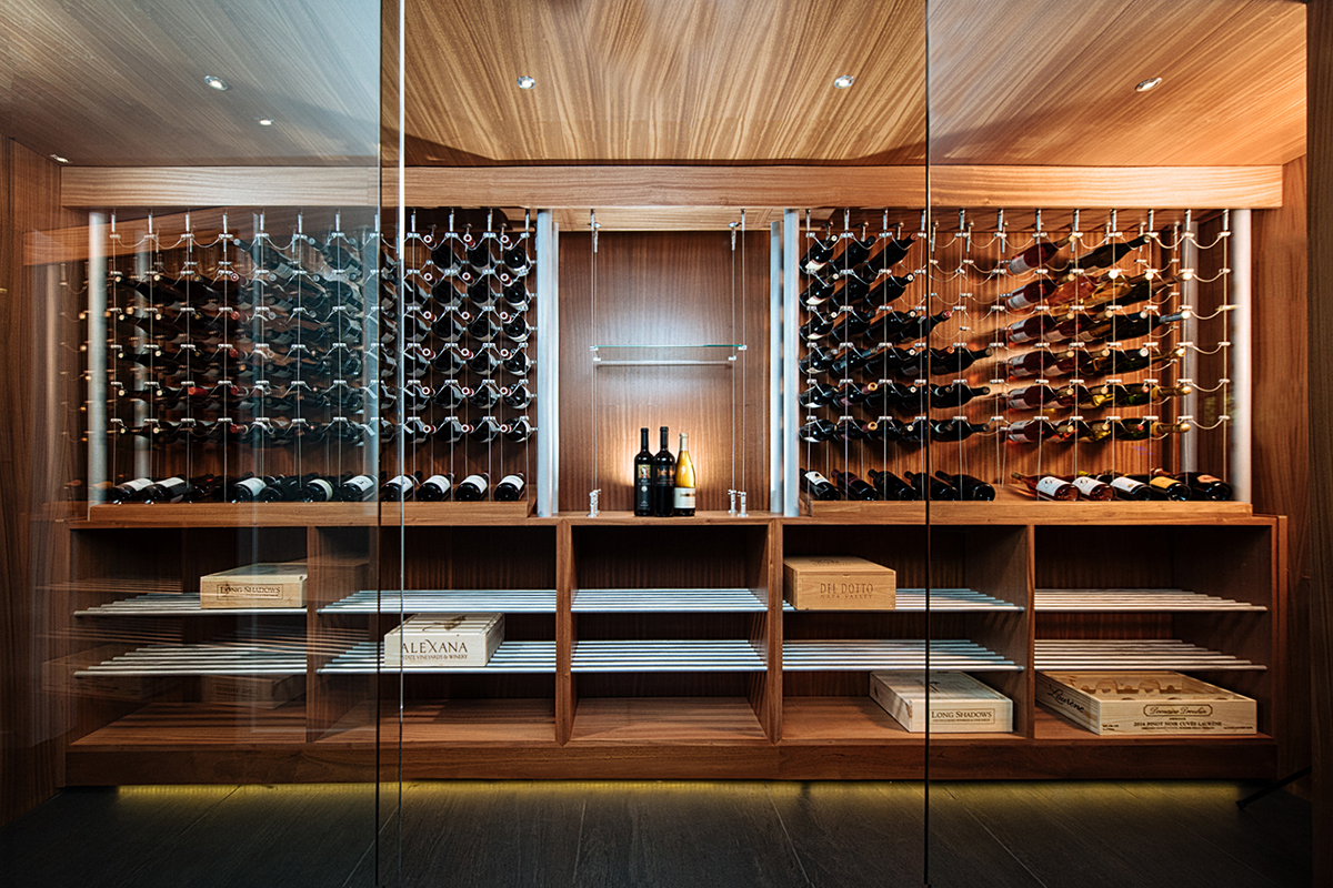 We often use glass doors to create a protected, but visually seamless entryway for a modern wine cellar.