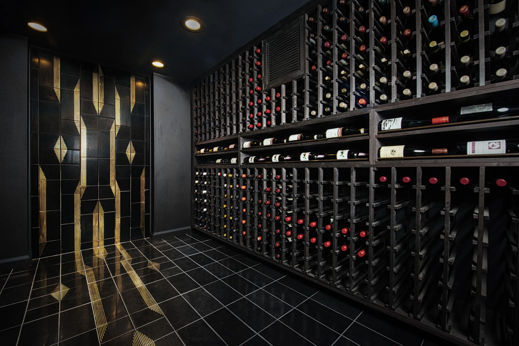 It’s okay to be daring when it comes to modern wine cellar design. This Art Deco inspired tiled wall treatment makes a big statement in an otherwise sleek wine room.
