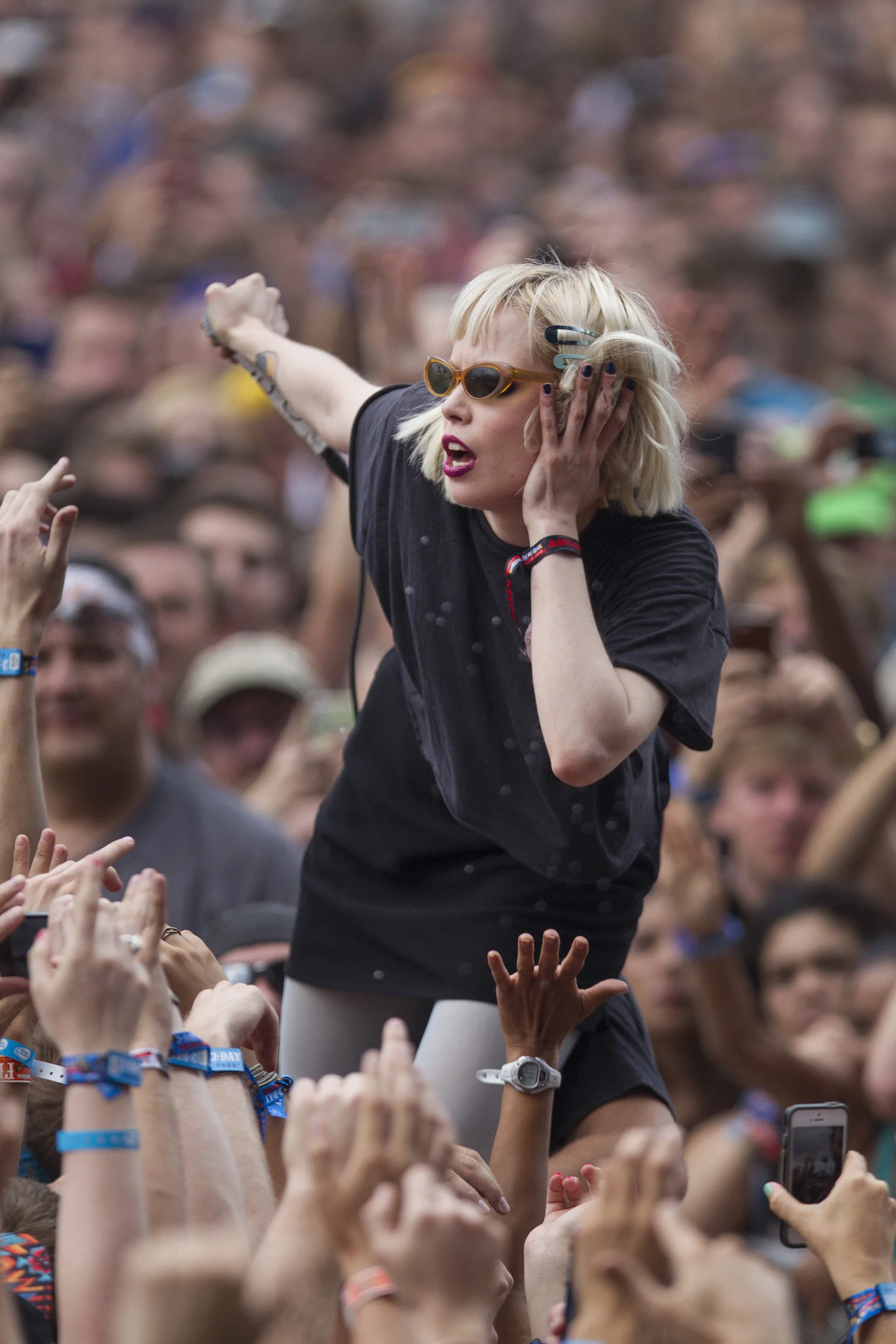 Alice Glass, vocalist for Canadian electronic band Crystal Castles interacts with fans after jumping off stage during their performance at the Lollapalooza Festival in Chicago, Friday, Aug. 2, 2013. The more than two-decade-old festival opens Friday in Chicago's lakefront Grant Park.