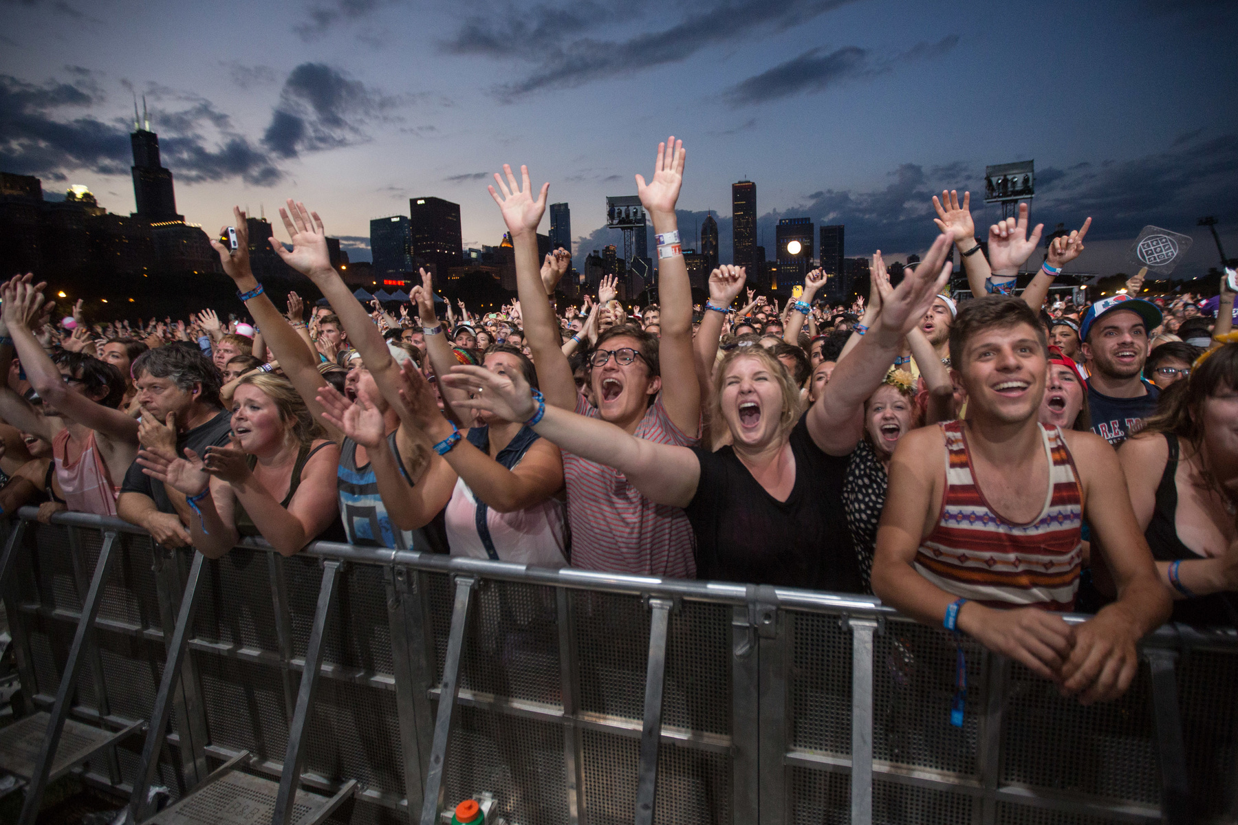 Fans react while Mumford & Sons performs at the Lollapalooza Festival in Chicago, Saturday, Aug. 3, 2013. The more than two-decade-old festival opened Friday in Chicago's lakefront Grant Park.