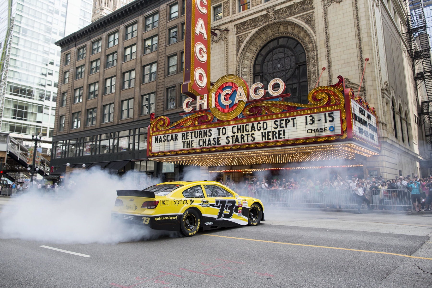 Dale Earnhardt Jr. performs a burnout in front of the Chicago Theatre in Chicago, Monday, Aug. 12, 2013. A triple header chase weekend starts at the Chicagoland Speedway Sept. 13. 