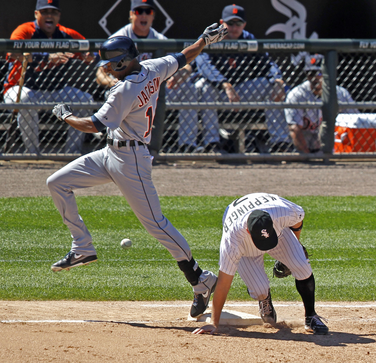 Detroit Tigers' Austin Jackson, left, reaches first on a throwing error by Chicago White Sox third baseman Conor Gillaspie to first baseman Jeff Keppinger, right, during the sixth inning of a baseball game Wednesday, Aug. 14, 2013, in Chicago. Matt Tuiasosopo and Omar Infante scored on the play.