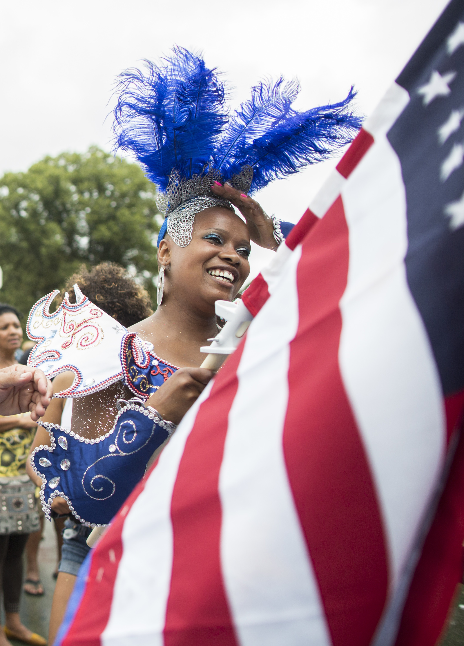 Riza Pereia dances with a flag during the Cape Verde Festival in Brockton on Sunday, July 27, 2014. Despite the foul weather, many came out to enjoy the dancing and music.