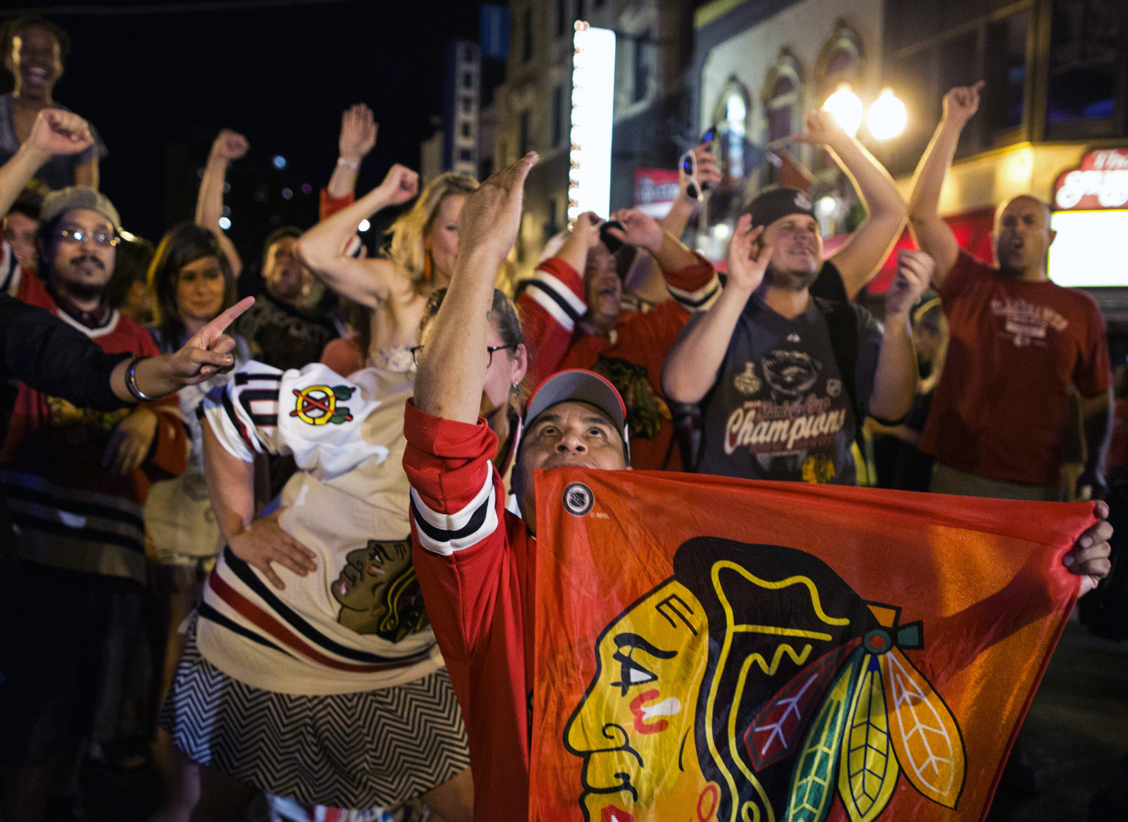 Fans celebrate on West Division Street in Chicago on Monday, June 24, 2013 after the Chicago Blackhawks won the NHL hockey Stanley Cup Finals on Monday, June 24, 2013. The Blackhawks defeated the Boston Bruins 3-2 in Game 6 to win the championship in Boston.
