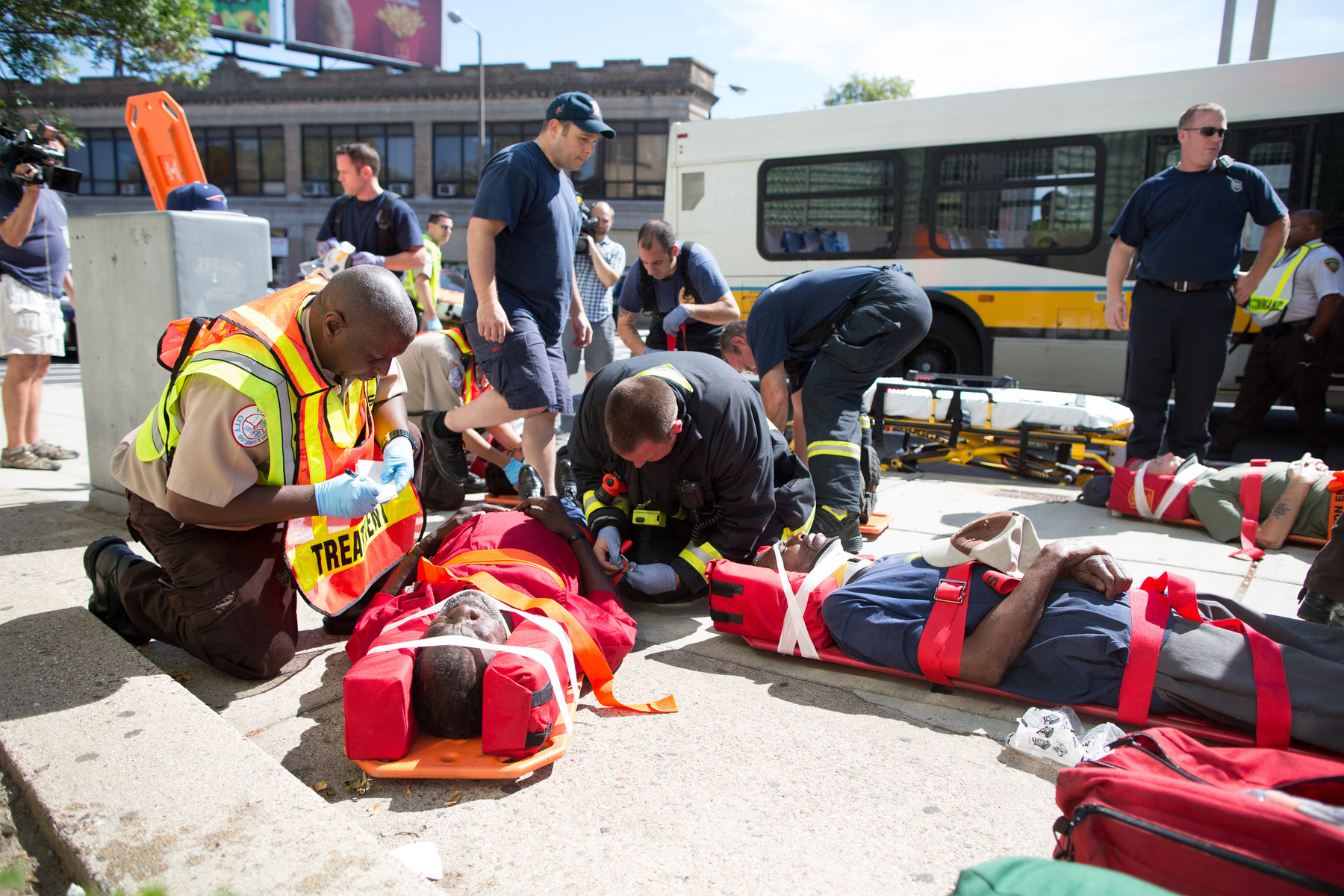 Boston, Mass. - Victims are treated and packaged by Boston EMS after a MBTA bus crashed into a tractor trailer that was part of the movie set of "The Heat" which stars Sandra Bullock on July 9, 2012. 15 people including the driver were transported to local hospitals after the crash.