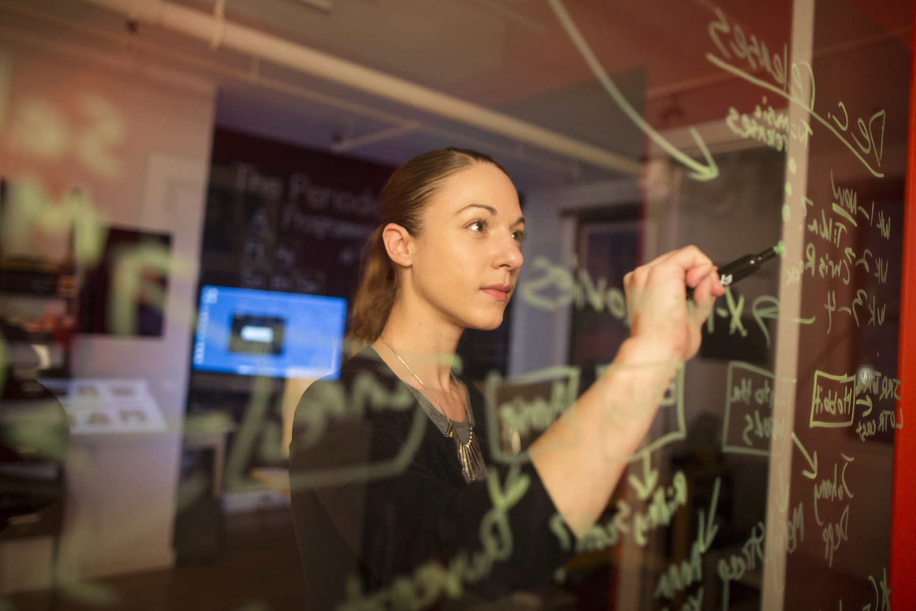 Marin Orlosky, the Outreach and Content Manager at PopSleuth, the maker of Endorfyn, a website that helps people find more of what they like, writes notes on the wall in her office in Cambridge, Mass. on Friday, Dec. 5, 2014.
