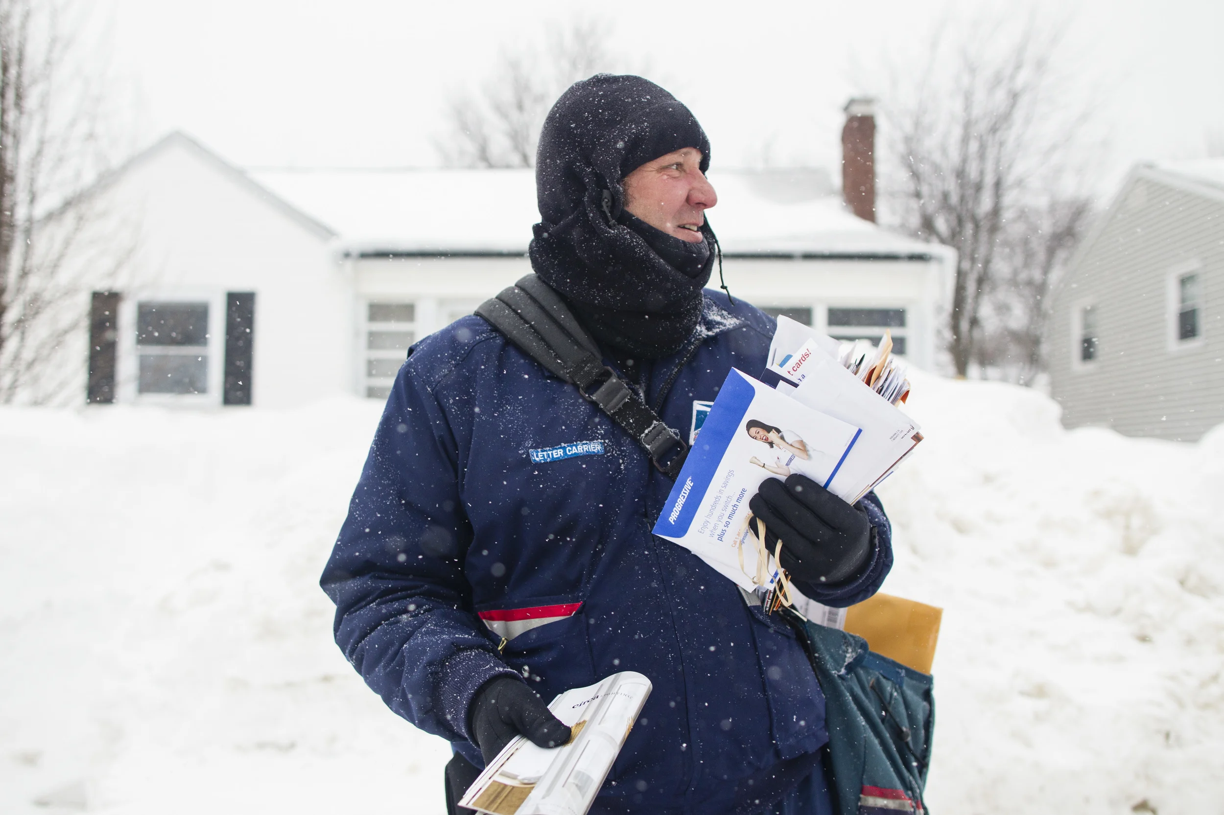   John Bachman, a letter carrier for the U.S. Postal Service (USPS), checks his remaining mail bundles while making deliveries in Hull, Massachusetts, U.S., on Saturday, Feb. 21, 2015. Bachman delivers mail on one of the region's most treacherous rou