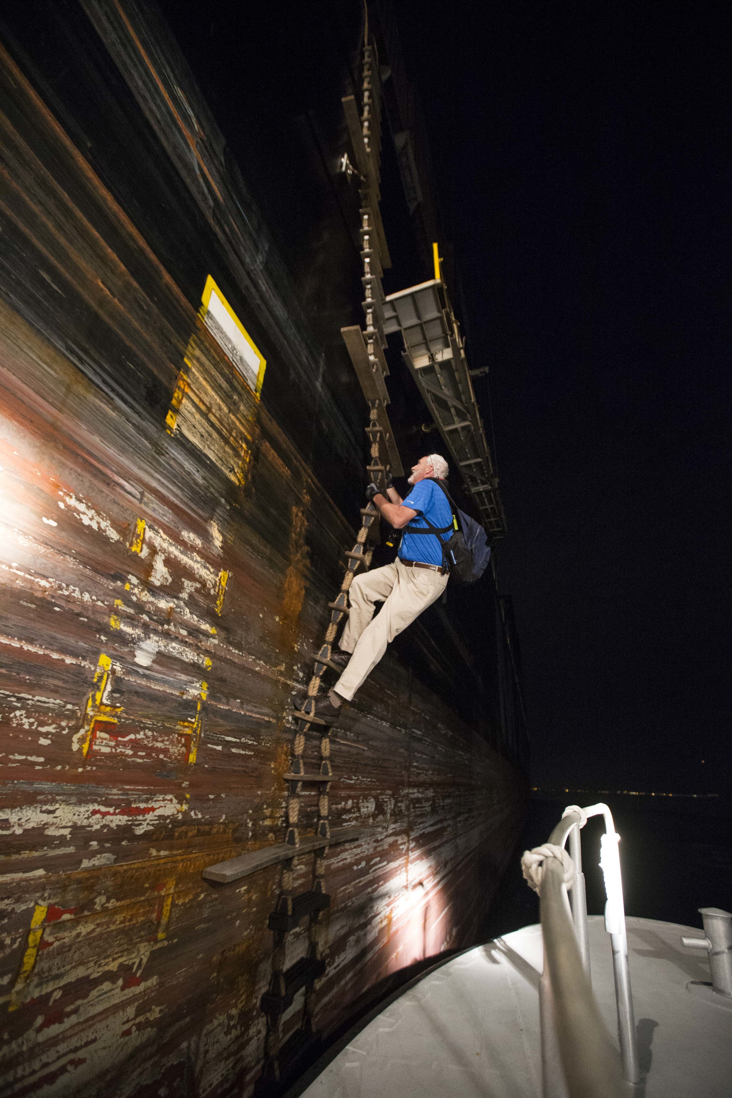  Boston Harbor Pilot climbs up the rope ladder of the cargo ship MSC Lorena as it continues to move at 15mph towards Boston Harbor on Aug. 16. 