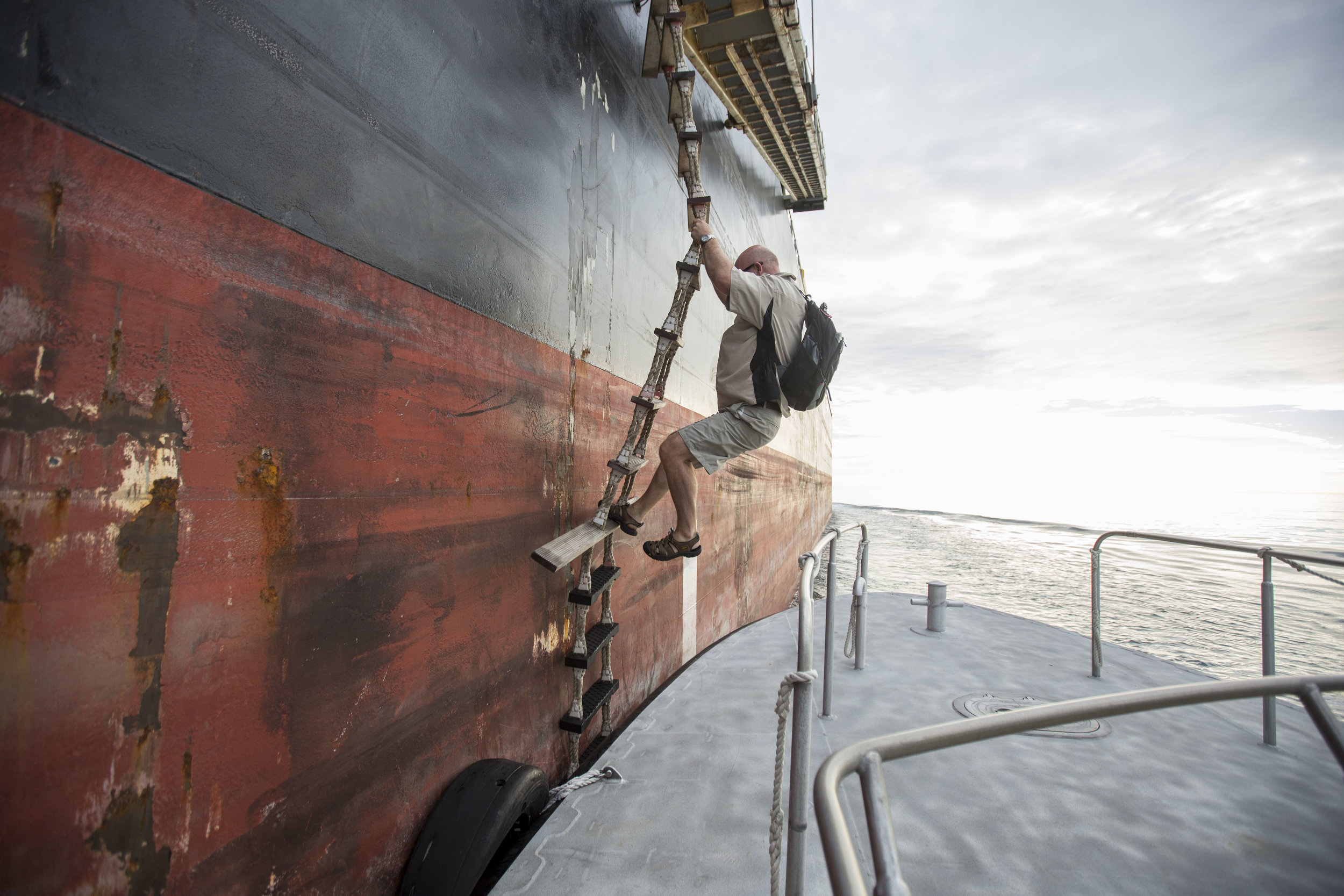  Boston Harbor Pilot Scott MacNeil climbs down from the 550 foot chemical tanker MTM St. Jean on the pilot boat "Chelsea" after guiding the boat out to sea near Boston Harbor on Aug. 16. 