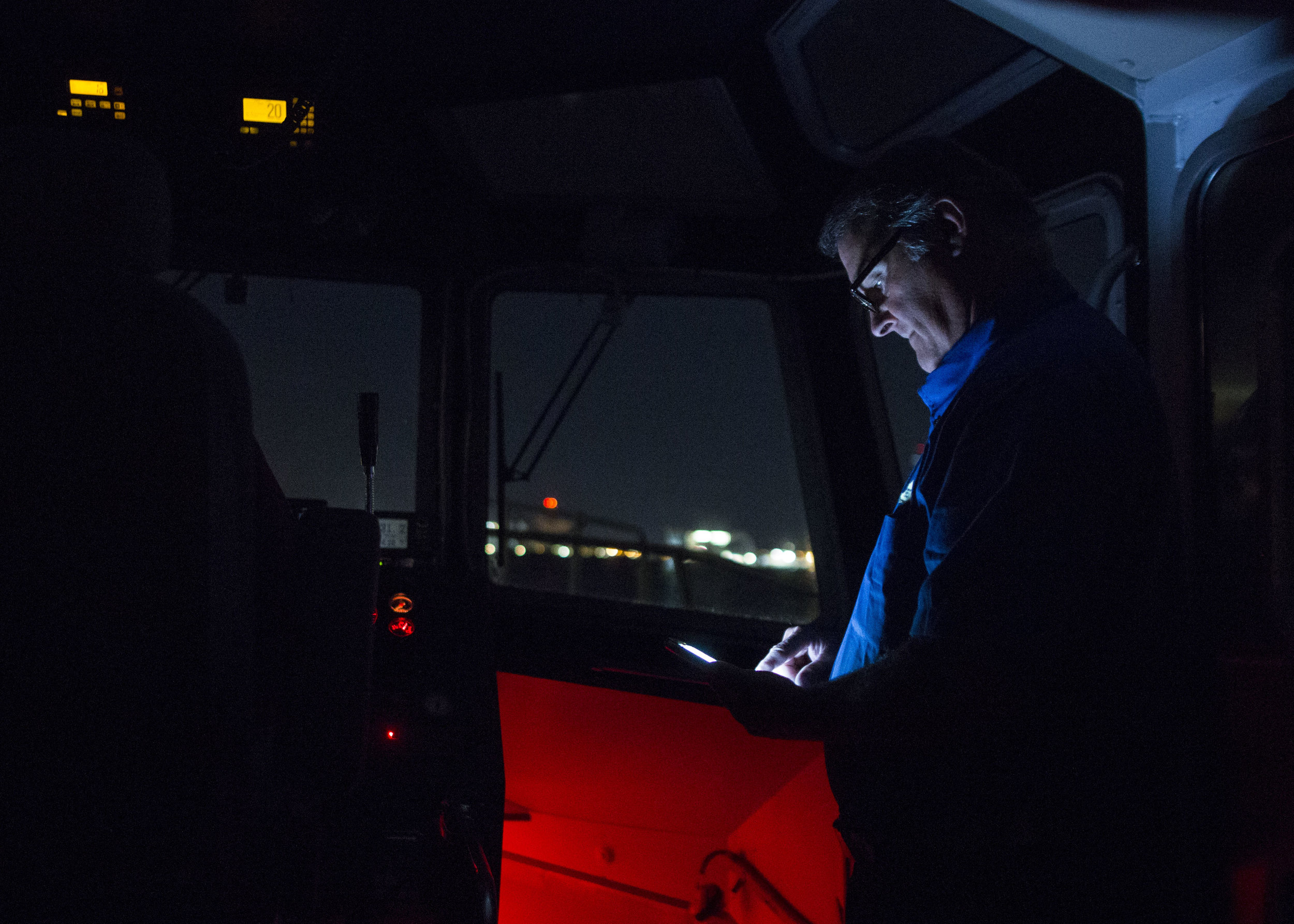  Boston Harbor Pilot Frank Morton checks wind conditions on his phone before boarding the car carrying ship Heroic Leader outside of Boston Harbor on Aug. 23. 