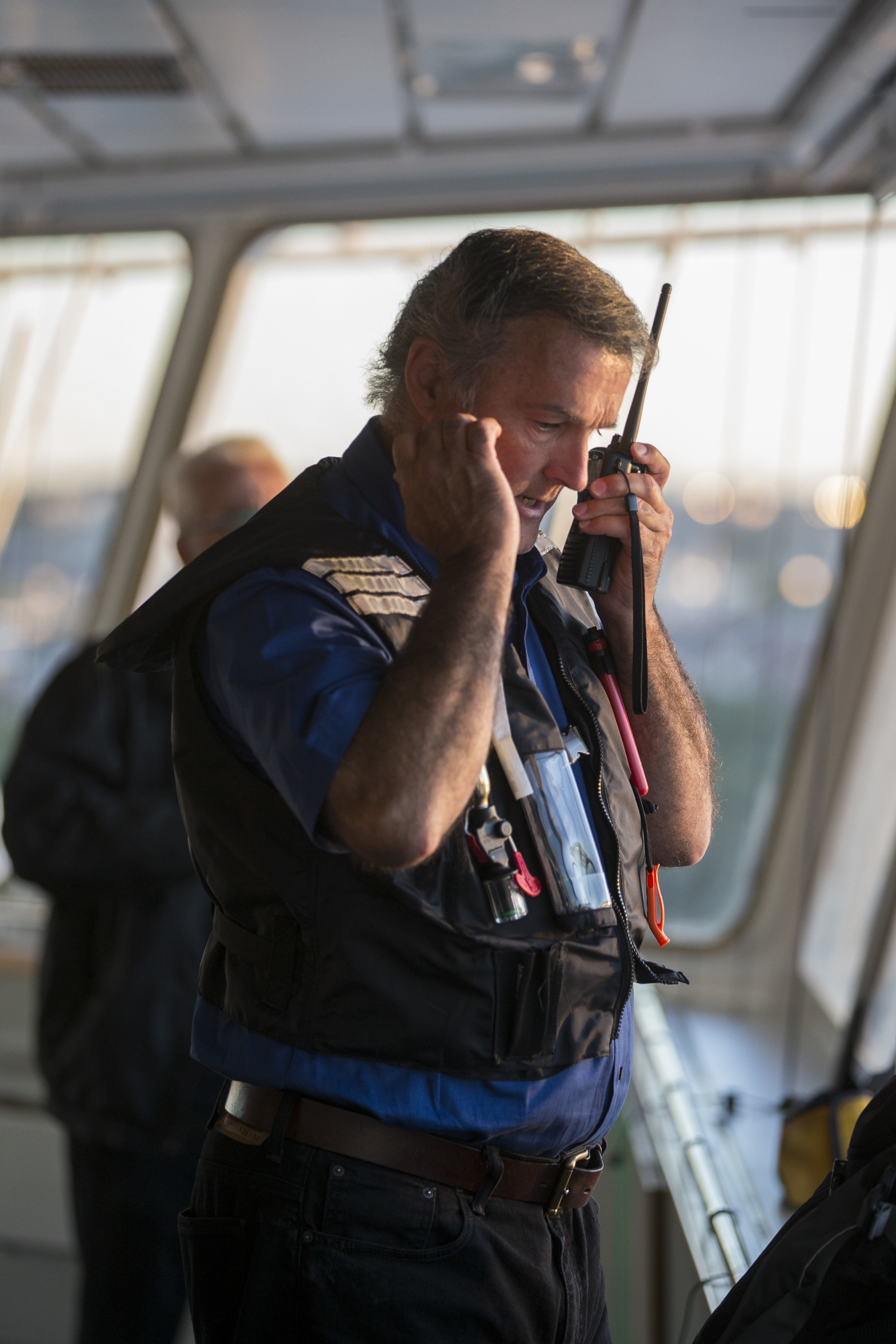  Boston Harbor Pilot Frank Morton talks to the pilot boat 'Chelsea' from the wheelhouse of the car carrying ship Heroic Leader in Boston Harbor on Aug. 23. 