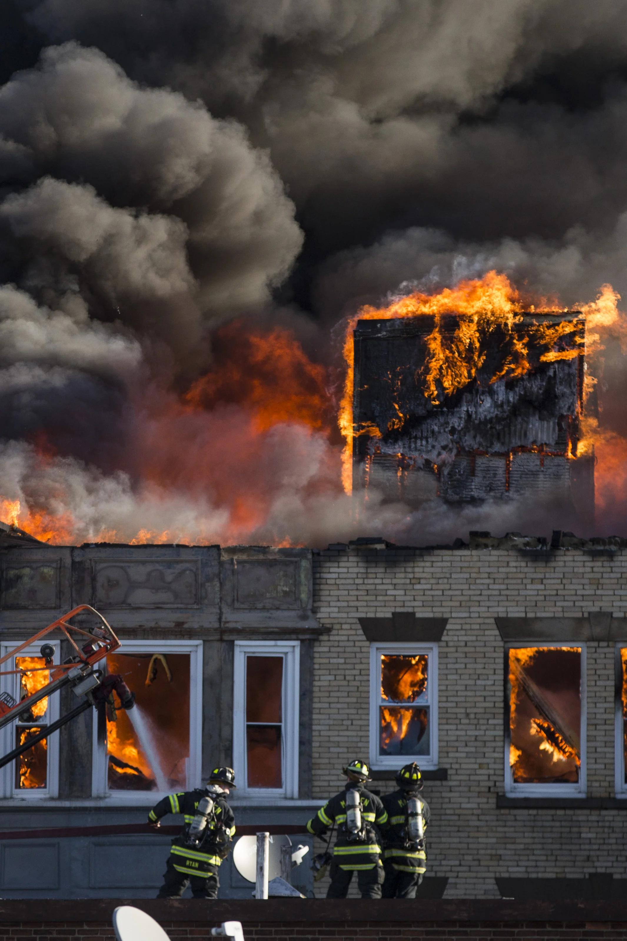  Firefighters prepare a defensive attack at a 6-alarm fire at 22 W. Baltimore St. in Lynn, Mass. on January 1, 2017. 