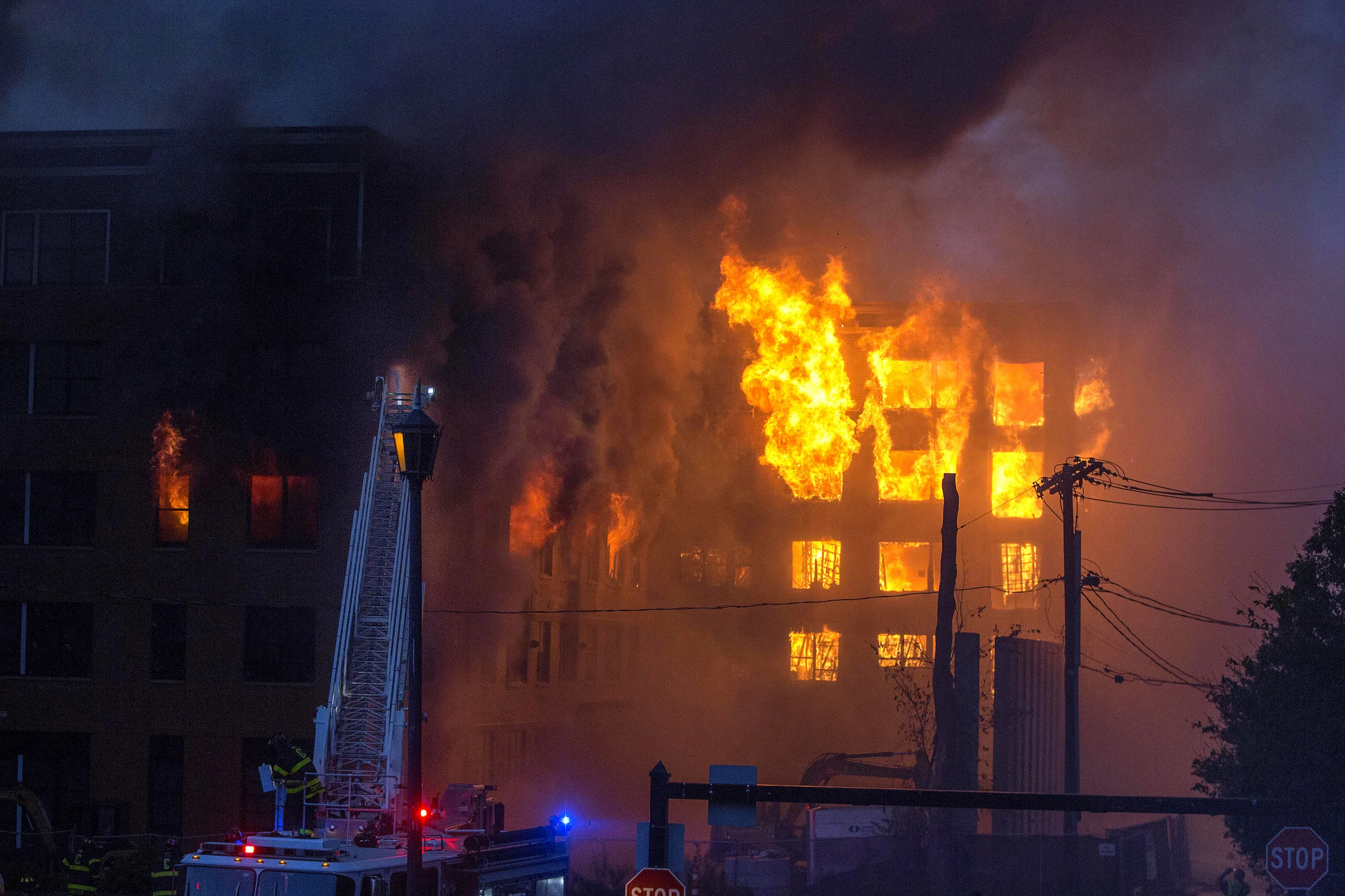  Firefighters put water on a fully involved building at the scene of an 8 alarm fire in Waltham on Sunday, July 23, 2017 that involved multiple structures. (Scott Eisen for The Boston Globe) 