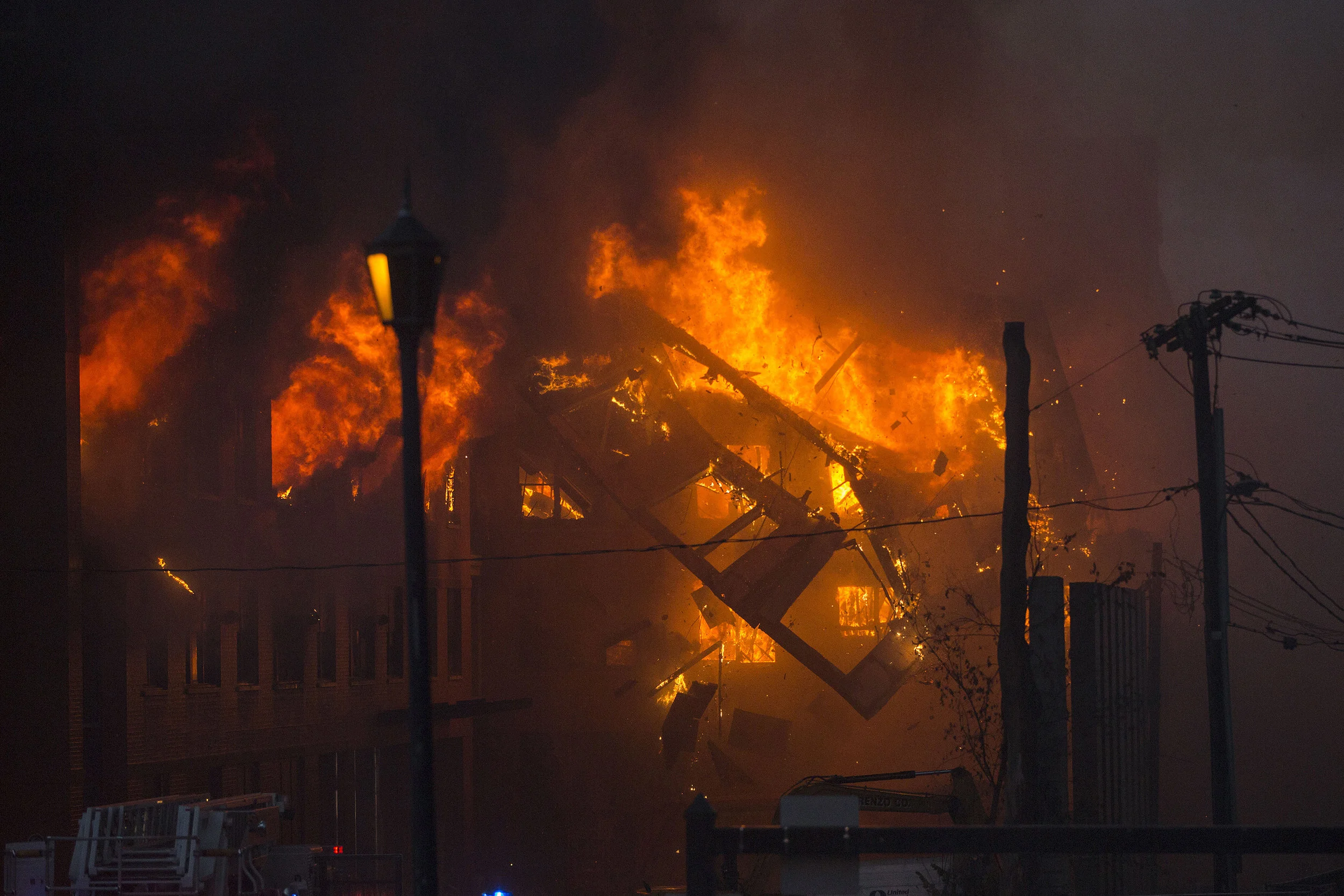  A part of a building collapses at the scene of an 8 alarm fire in Waltham on Sunday, July 23, 2017 that involved multiple structures. (Scott Eisen for The Boston Globe) 