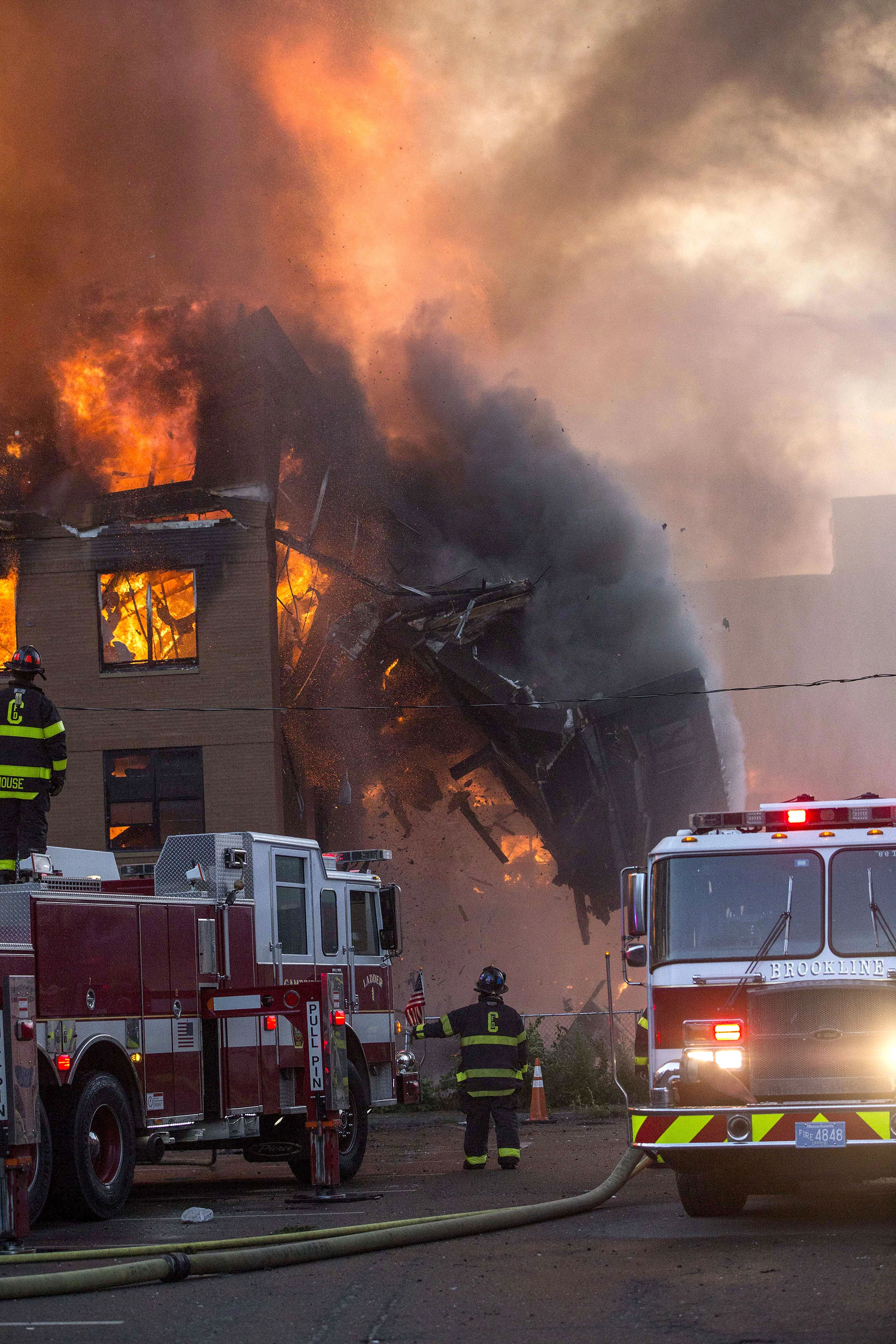  A building collapses at an 8-alarm fire where multiple buildings were fully involved in Waltham on Sunday, July 23, 2017. (Scott Eisen for The Boston Globe) 