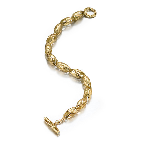  18k Yellow Gold crownwork conch shell bracelet with diamond set bale. 