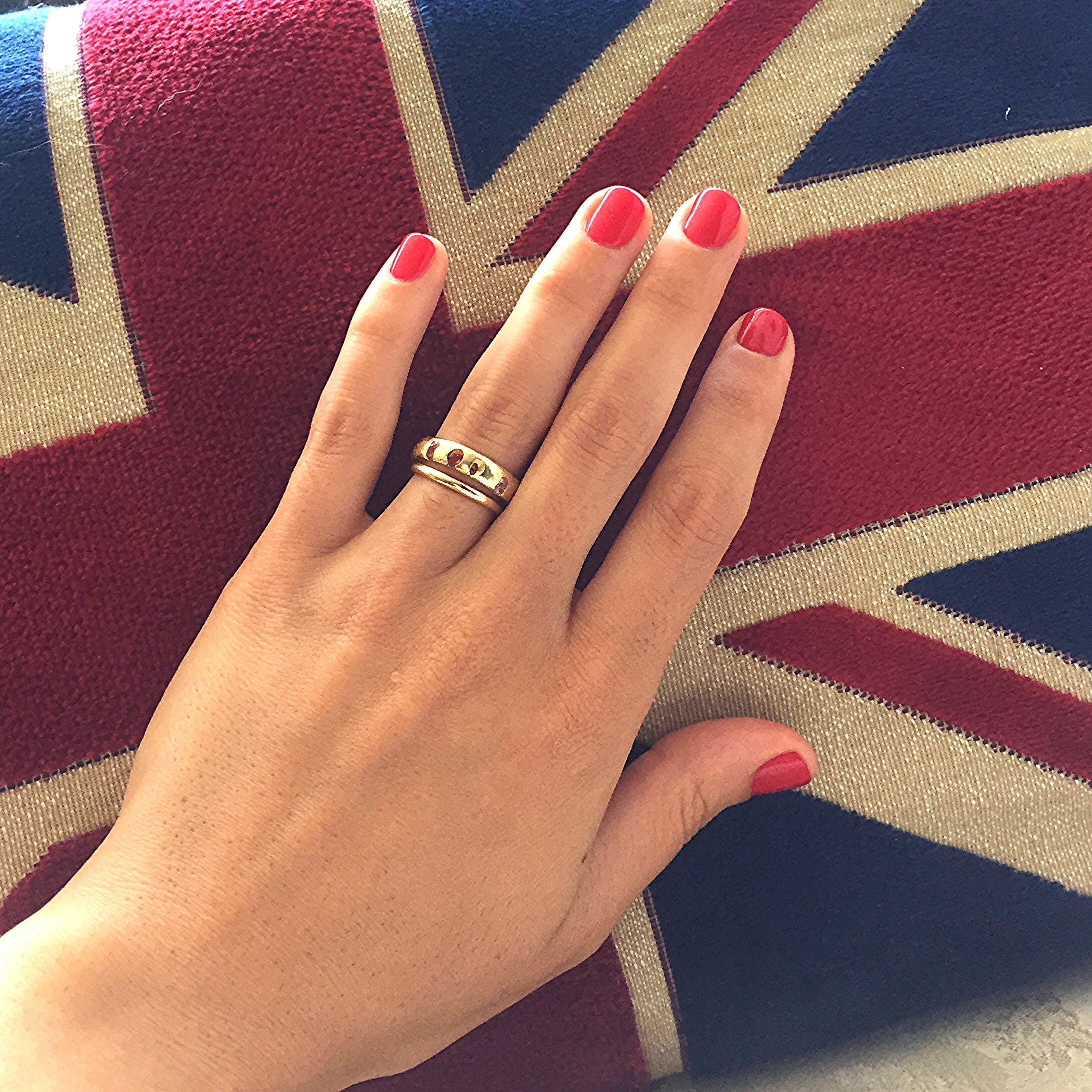   Signature multi sapphire band on Meaghan's hand for scale. And a Union jack pillow bc Polly's British.  