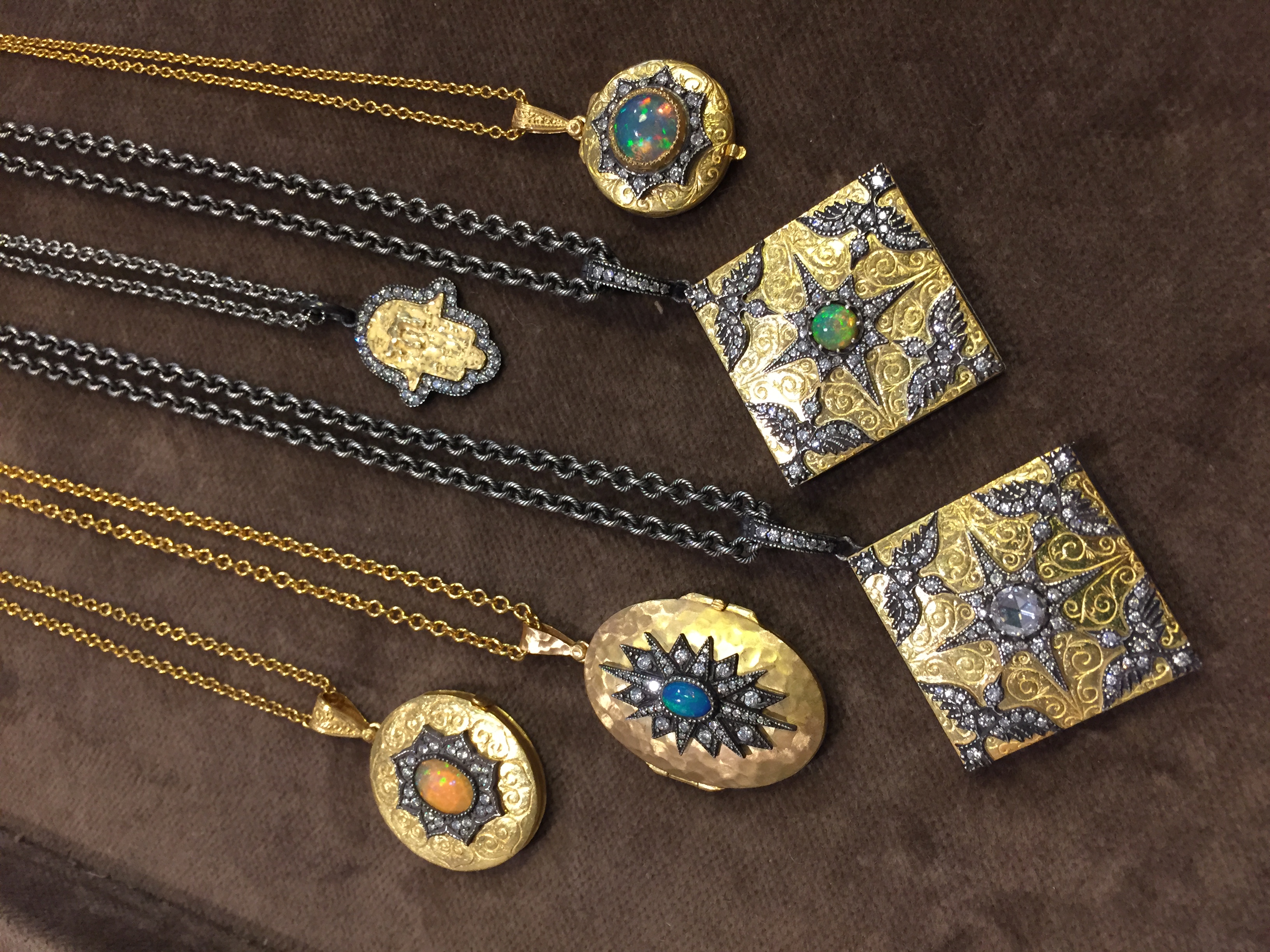  A selection of exceptional hand-carved 22k gold and silver lockets and pendants with gemstone and diamond accents, available at  Art &amp; Soul , Boulder, CO.&nbsp; 