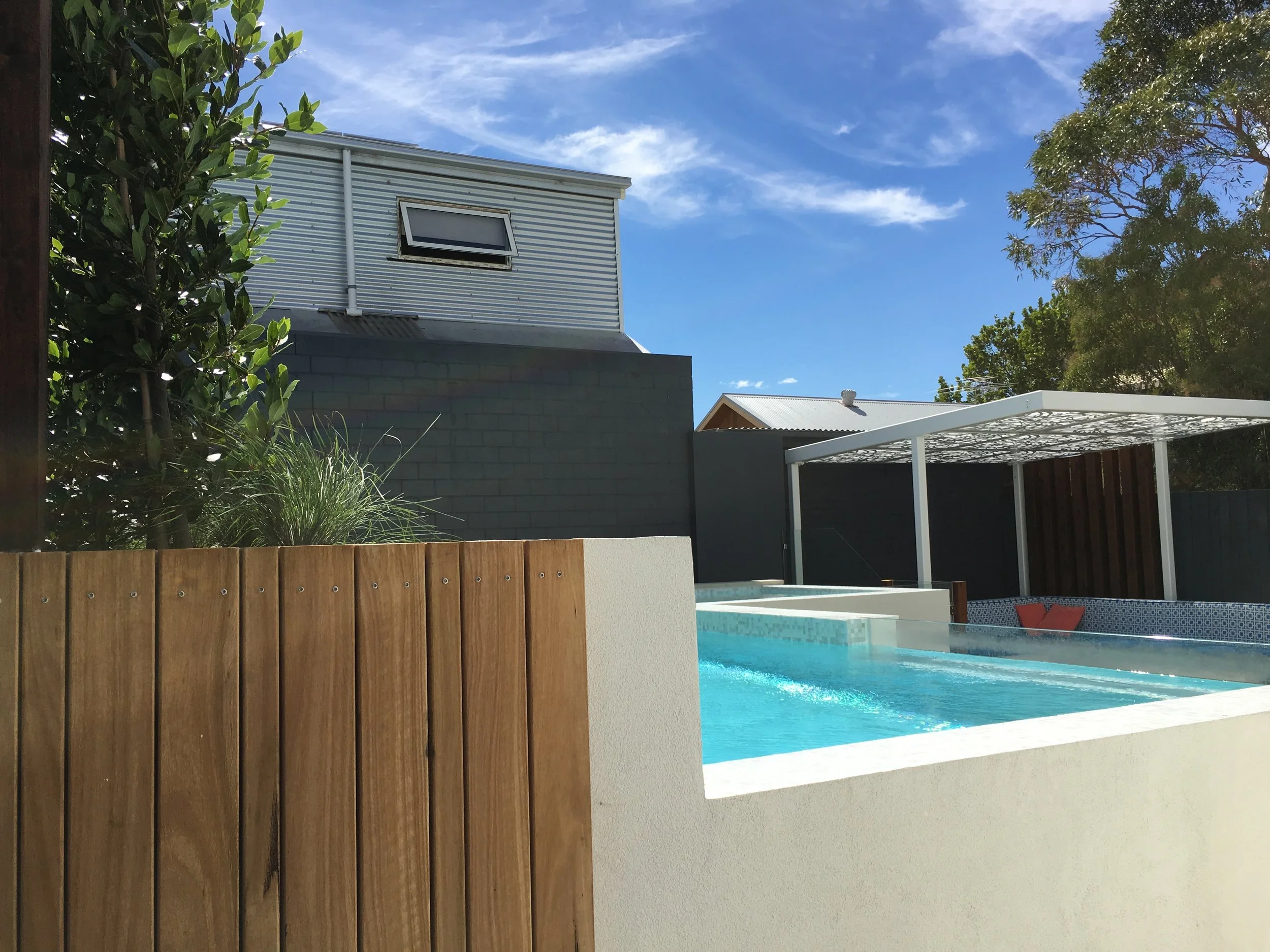 Timber decking pattern is wrapped around the other side of the planter - and provides connection to the other areas of the garden - this is the view from the dedicated side entry to the backyard.