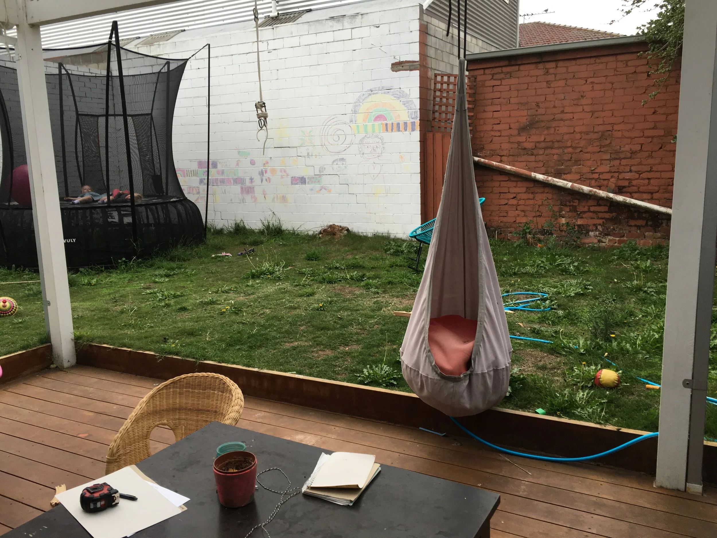 Before: View from the house. The trampoline is located at the site of future pool and spa areas.