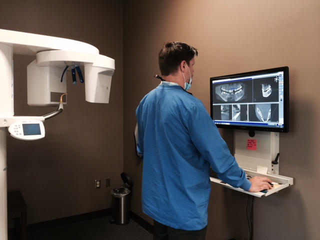 Dr. Palomaki viewing the 3D radiograph in preparation of placing a dental implant.