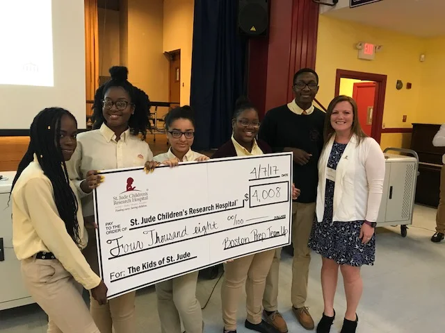 A representative from St. Jude's visited a Boston Prep community meeting to accept the donation, thank the school community for their support, and share her hopes that next year's National Honor Society officers will choose to make St. Jude's a beneficiary of their work in the community again.